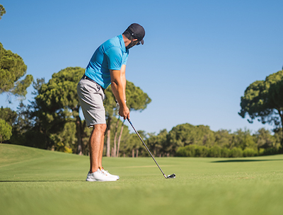 golfer about to hit a golf ball