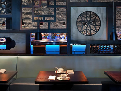 Internal view of an elegant bar with wooden tables and coffee cups