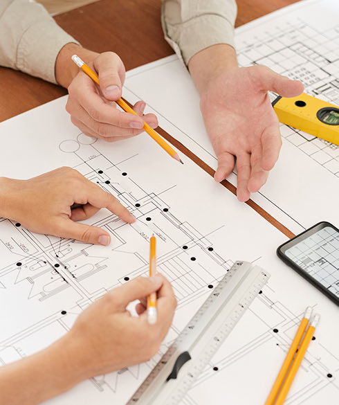 Close up of two people reviewing an Architectural Drawing 