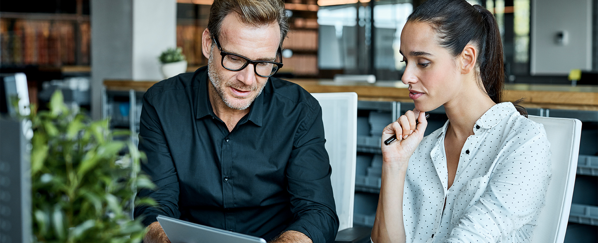 lady and man looking and working on something on the laptop