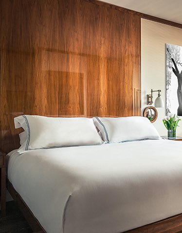 a large bed with white linens