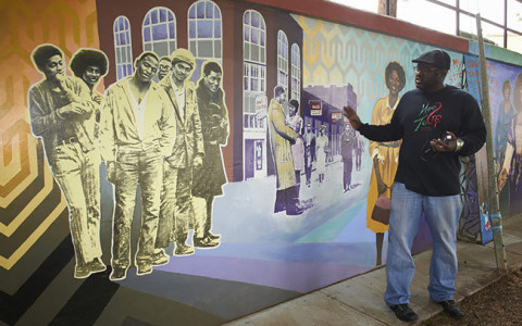 Man standing in front of a mural