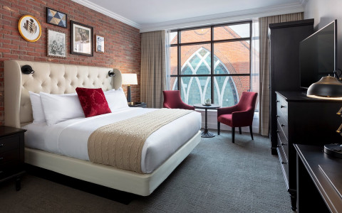 foundry hotel room with upholstered headboard large windows 