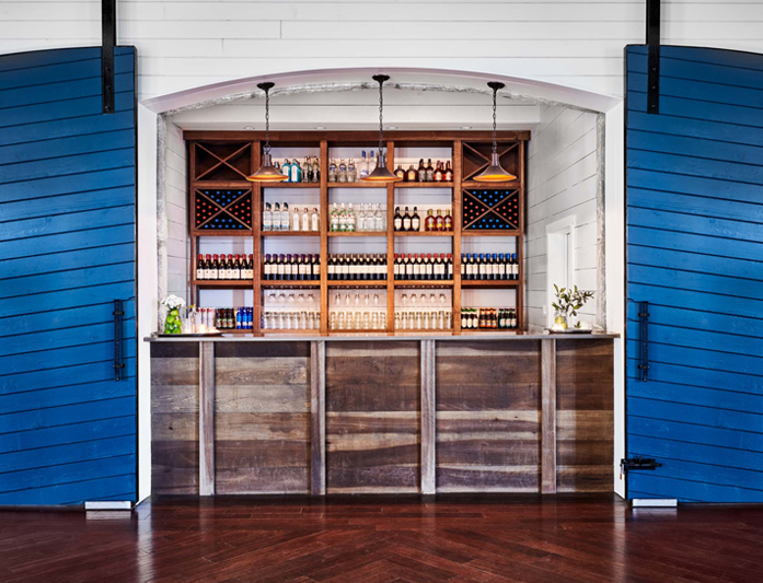 fully stocked bar in what looks like a stable