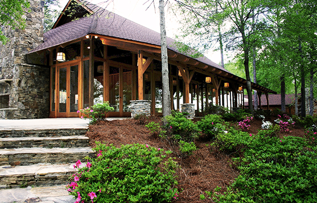 Small garden next to stairs leading to wooden event ballroom