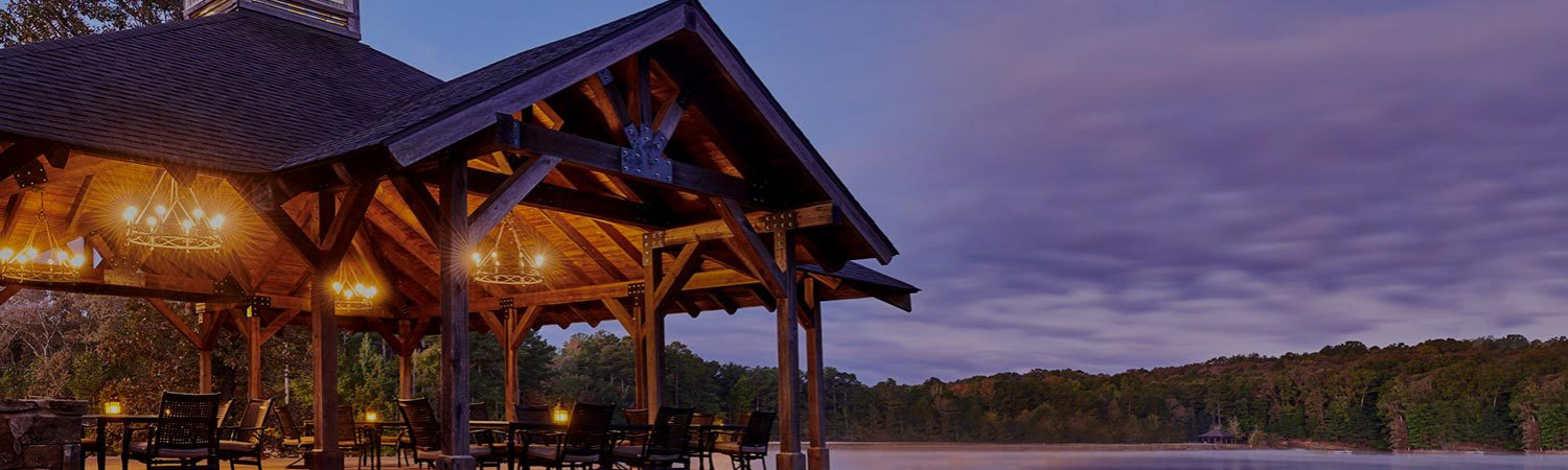 event venue with lights on the outside and the sky is a purple gray tone