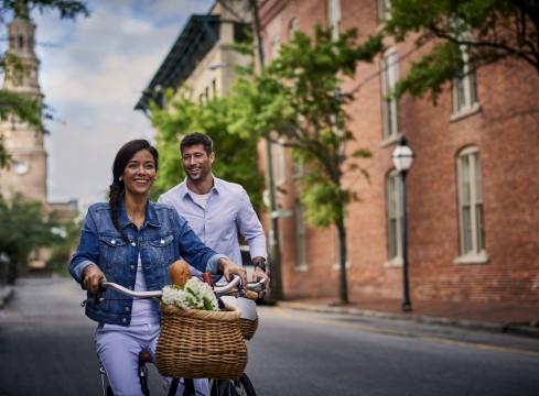 couple on bikes with baskets