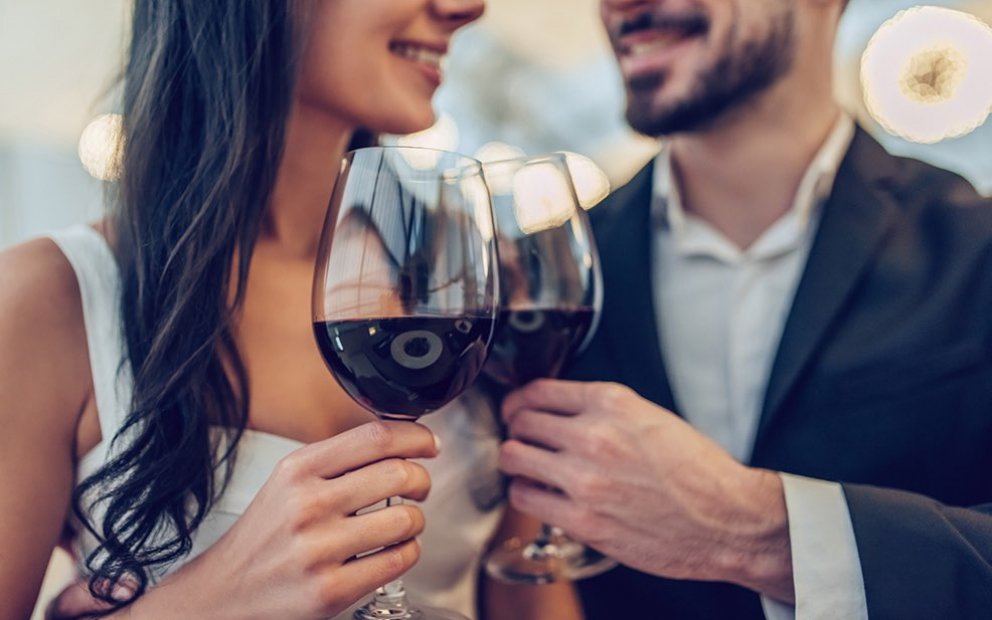 Close up of couple toasting with red wine