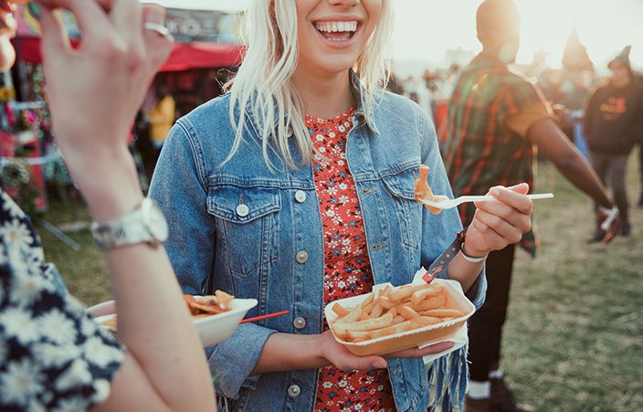 woman at a fair eating fries