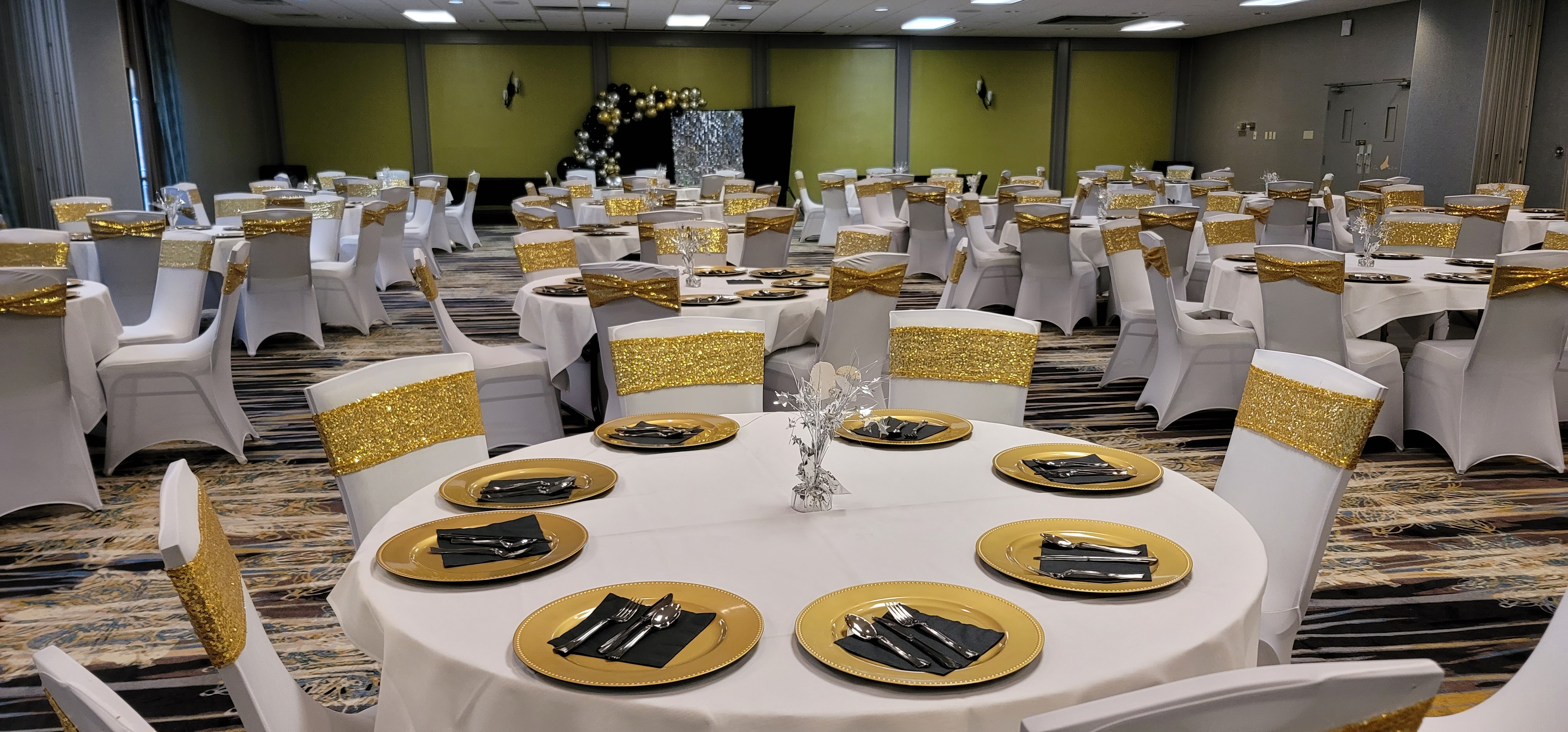 large meeting room with gold accents and round tables
