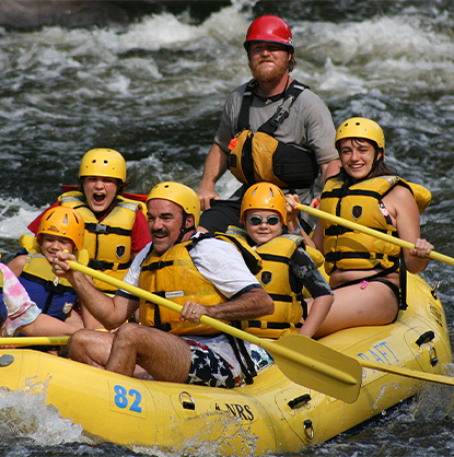 family on yellow raft on river