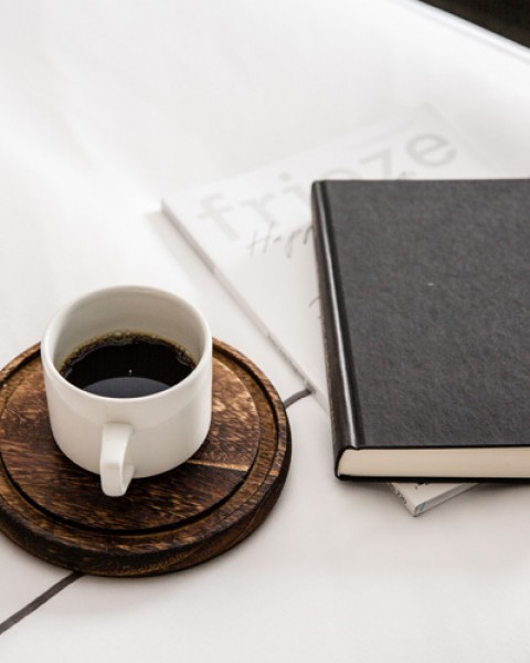 coffee and a book on a bed