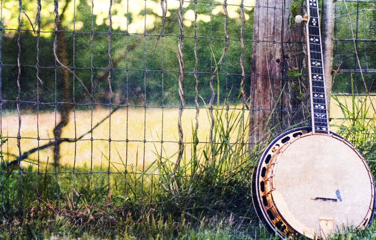 Banjo leaning on fence