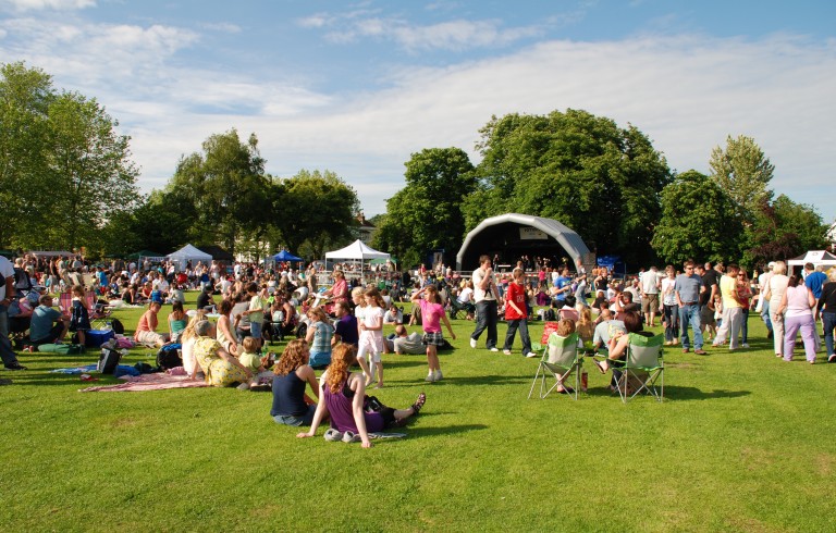 Crowd sitting on grass for event