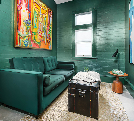 green room with green couch and coffee table