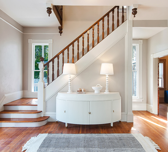 grand maloney foyer - with rug and entry table with two lamps