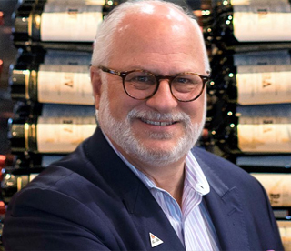 close up shot of william kohl in front of a wine cellar