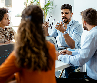 image of a man speaking at a meeting