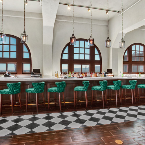 view of a large bar with teal barstools