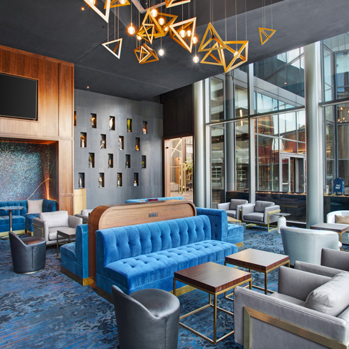 classy lounge area with blue couches and gray chairs