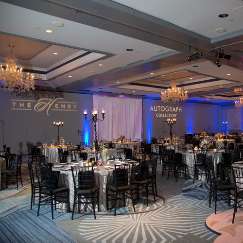 large indoor venue with elegant chandeliers and blue lights