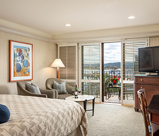 clean bedroom with a view of the ocean