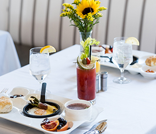 elegant dishes and drinks with a sunflower centerpiece
