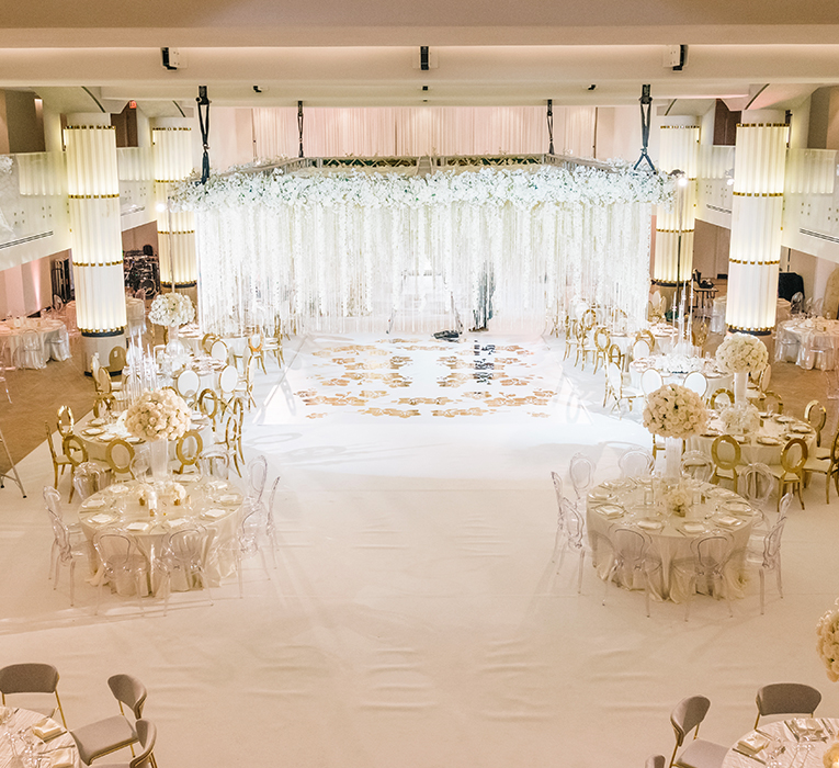 wedding reception set up with white flowers and drapery