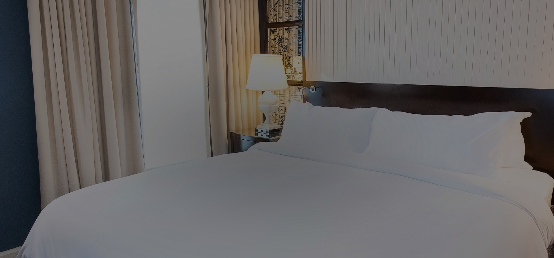king bed of a hotel accommodation with a white blanket