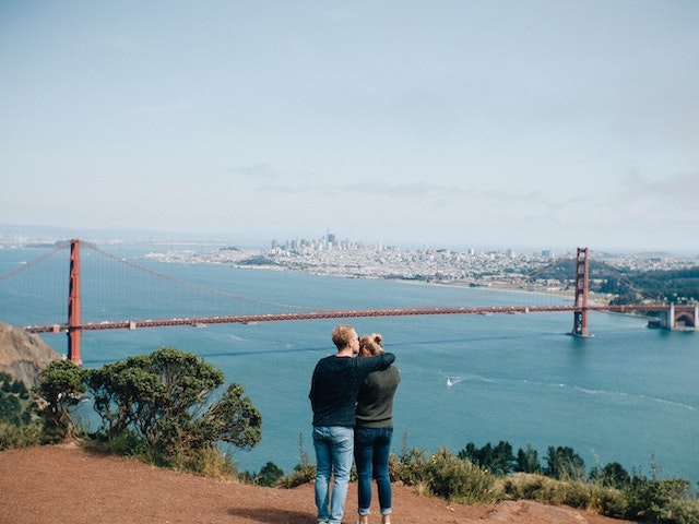 couple overlooking golden date bridge and bay