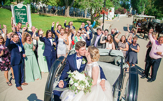 View of a just married coulple kissing on a carriage