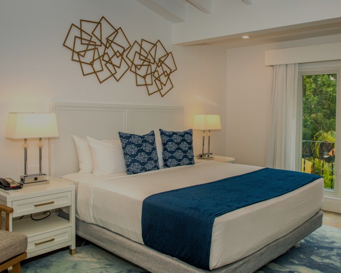 harbour villa bedroom with bed and wall art