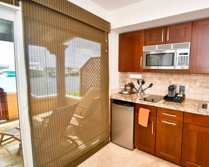 small kitchen area with sliding doors leading to balcony