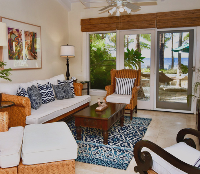 living room with white and blue furniture and balcony door in the back