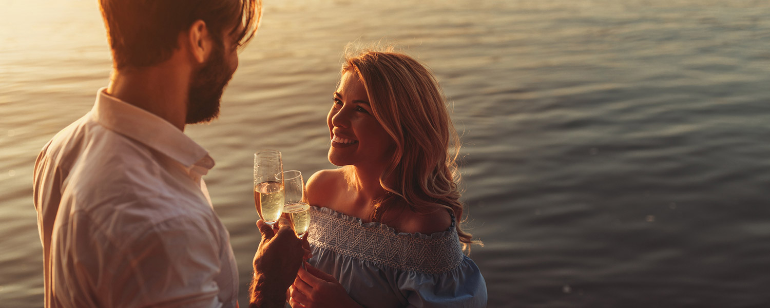 couple toasting and looking at eachother romantically