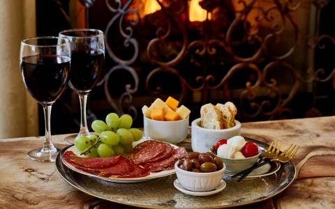 charcuterie platter with two glasses of wine