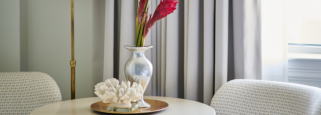 Detail image of a side table and chair in a guest room