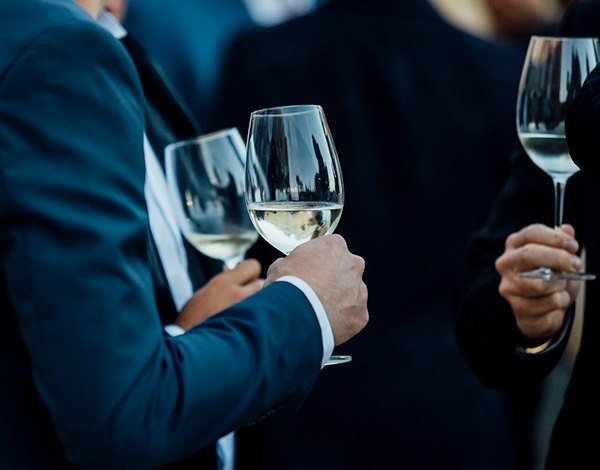 business professionals holding glasses of wine