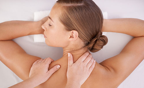 Hands massaging woman's back at the spa
