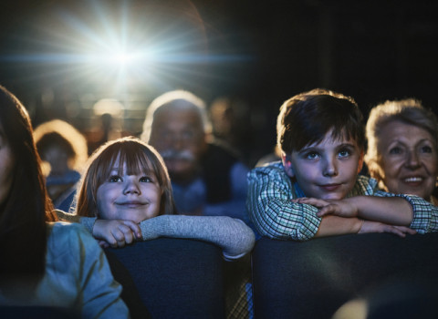 children in theater at the edge of their seats