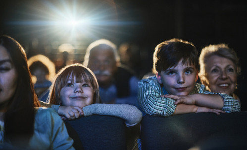 children in theater at the edge of their seats