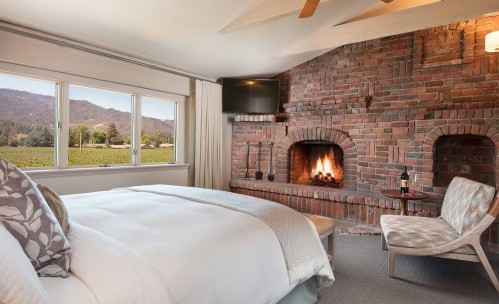 bedroom with king bed and fireplace
