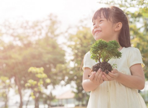 little girl holding plant