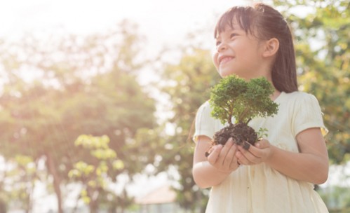 little girl holding plant