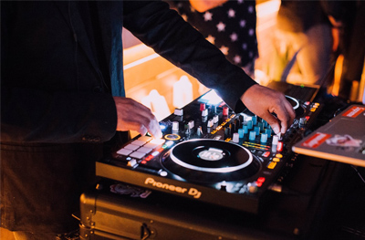 a man playing music on a dj controller