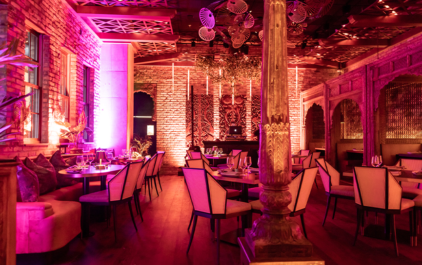 interior of a restaurant with pink lights 