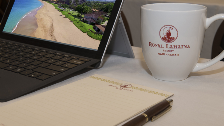 view of a tablet, a notepad, a pen, and a mug