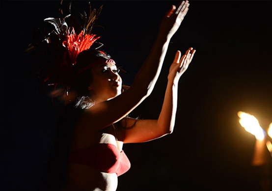 a woman performing at a luau
