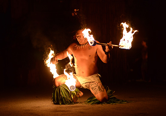 view of fire dancers at a luau
