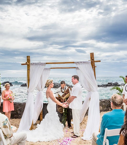 view of a couple getting married on the beach